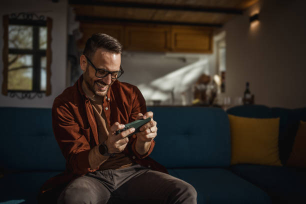 istock Man playing video games on his smartphone 1873308638