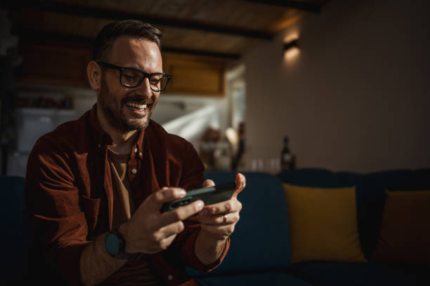 istock Man playing video games on his smartphone 1873308643