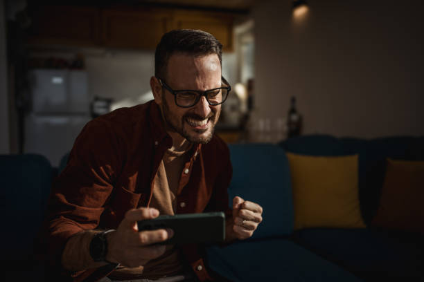 istock Man playing video games on his smartphone 1873308649