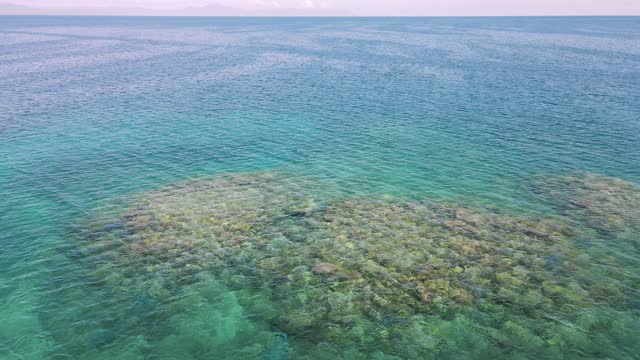 Flying low over a healthy coral reef system in The Great Barrier Reef Marine Park. Drone view