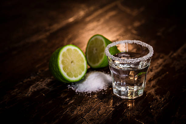 Tequila shot with salt and green lime Tequila shot with salt and green limeTequila shot with salt and green lime tequila shot stock pictures, royalty-free photos & images