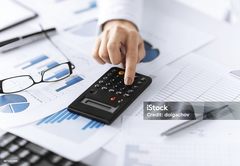 woman hand with calculator and papers picture of woman hand with calculator and papers Adult Stock Photo