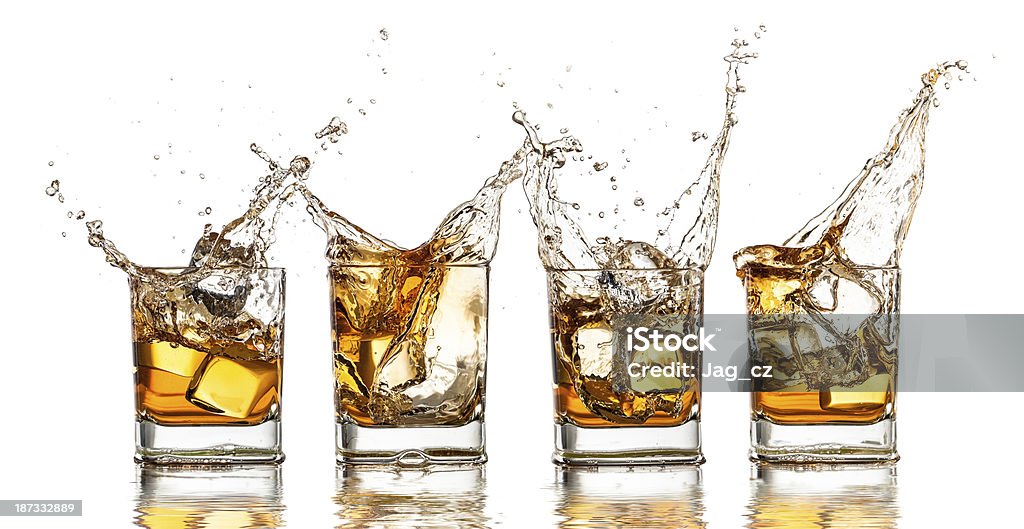 Whiskey Whiskey glass with splash, isolated on white background Alcohol - Drink Stock Photo