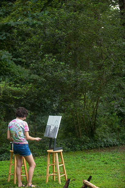 istock Young Woman Painting 187337088