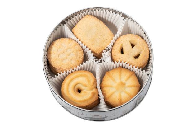 istock Metal box decorated with dolls plus sugary butter cookies, on a white background. 1873373633