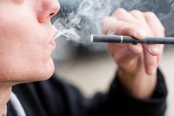 Smoking E-Cigarette stock photo