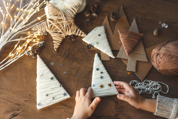 istock Child makes Christmas decoration from yarn 1873383993