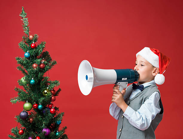 istock Little boy with santa hat Shouting With Megaphone 187341240