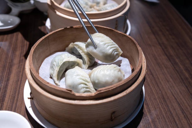 istock steamed dumplings in bamboo steamer, chinese cuisine 1873422011