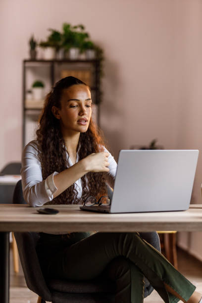 istock Young woman reading something on her laptop screen at her desk 1873431838