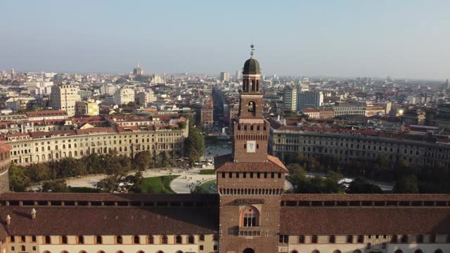 Milan castle tower on cityscape behind, aerial drone view