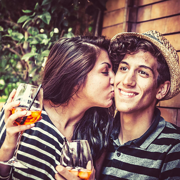 Teenage Couple Enjoying Aperitif with Alcoholic Drinks
