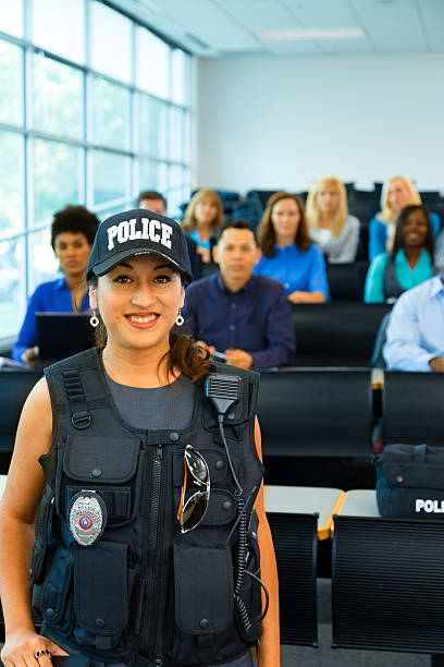 istock Law:  Policewoman speaks to potential police cadets. 187343372