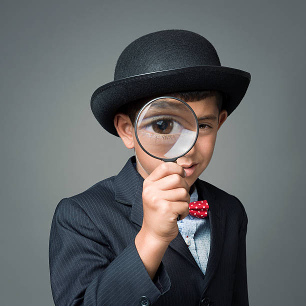 istock Little detective looking through magnifying glass 187343437