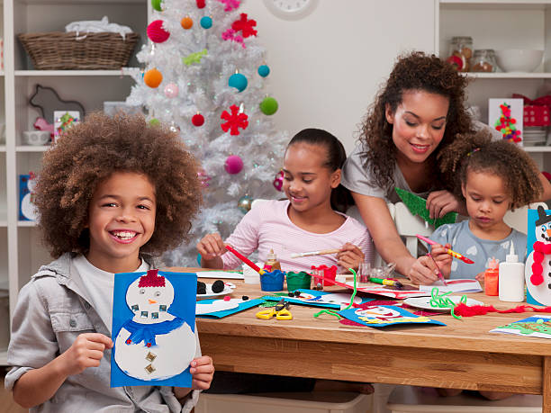 istock Cute mixed race boy holding handmade Christmas cards 187344205