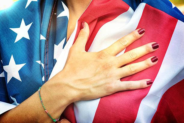 American Fan Putting Hand on Hearth During the National Anthem  national anthem stock pictures, royalty-free photos & images