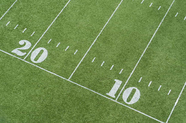 A top view of part of the sideline of an artificial turf football field.