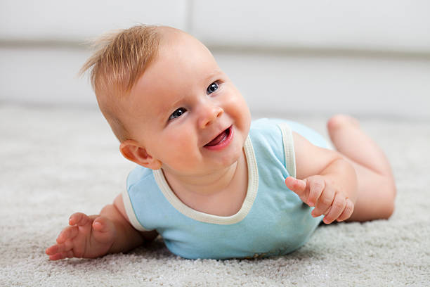 istock Happy baby boy on the white carpet 187344873