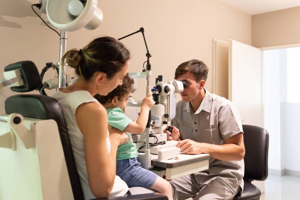 istock Ophthalmologist examining the vision of a small child 1873456824