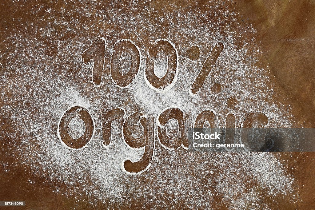 Organic Written On Flour "100 % Organic" written on flour. Baked Pastry Item Stock Photo