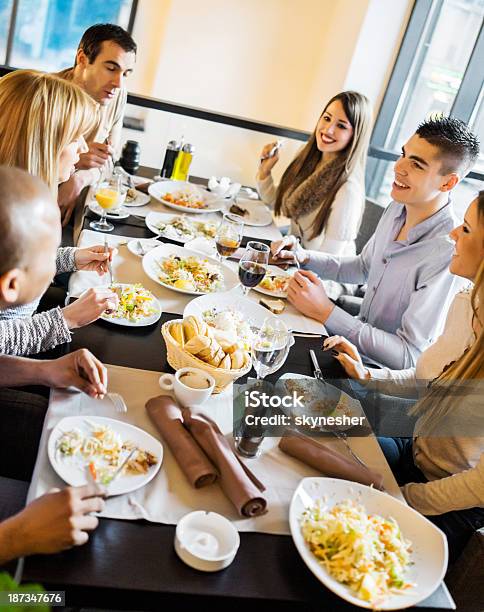 Group Of Smiling People On A Dinner Stock Photo - Download Image Now - Dining, Dinner, Discussion