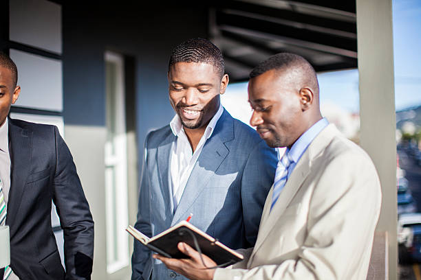 istock Colleagues reviewing work load outside their office. 187348754