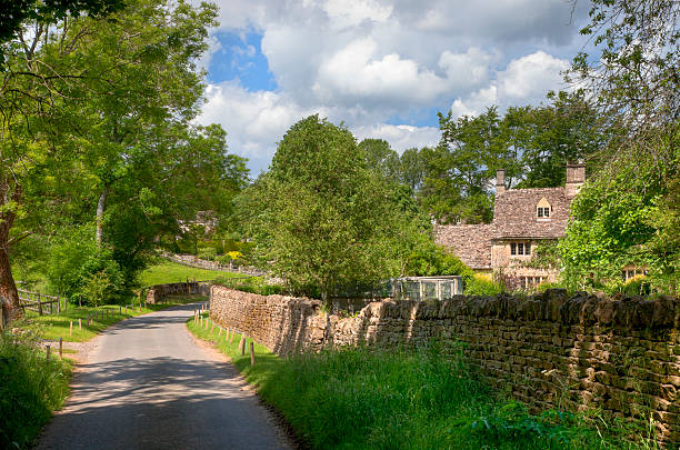 istock Cotswold lane with cottage 187348978