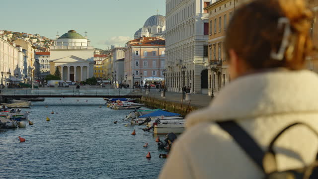 SLO MO Rear View of Female Tourist Photographing Canal and Buildings with Smartphone in Trieste