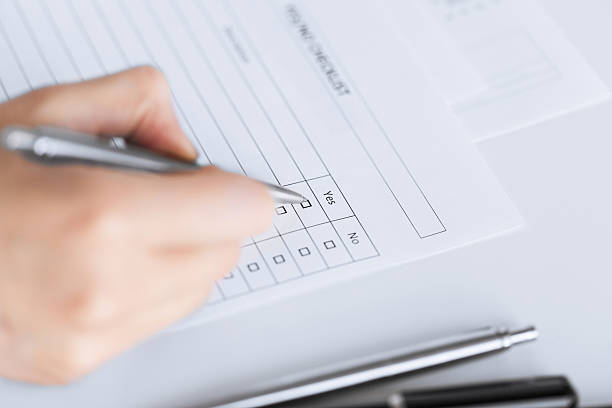 istock woman hand with blank questionnaire or form 187351323