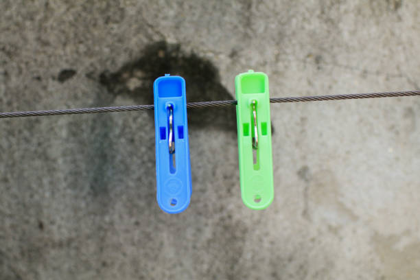 istock Multi colored clothespins on the rope for drying clothes, Housework and household concept. Clamping clothes that are dried in the sun so they don't come loose in the wind. 1873516109