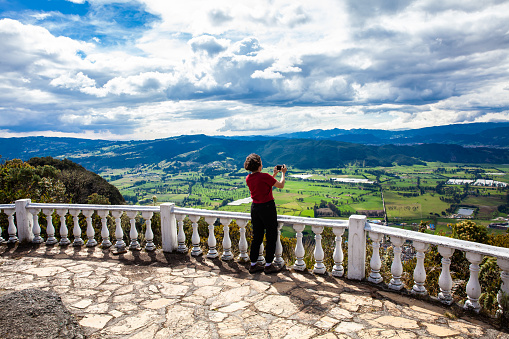 Young woman at a viewpoint over the beautiful Sopo valley at the department of Cundinamarca in Colombia
