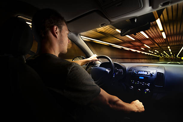 jovem adulto condução sobre o limite de velocidade em um túnel. - car dashboard night driving imagens e fotografias de stock
