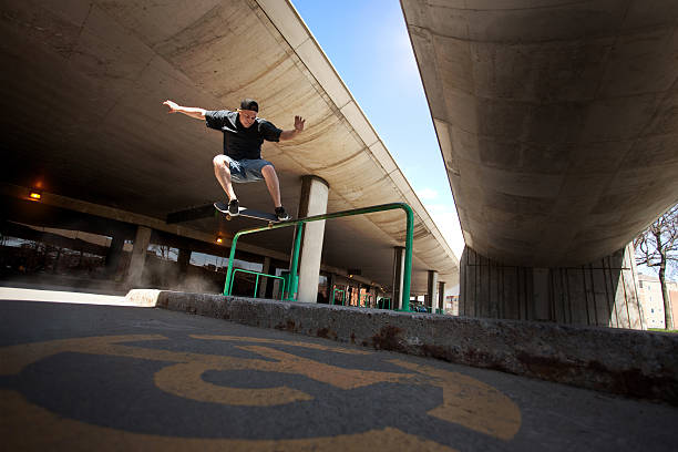 Skateboarder doing Crooked Grind trick on a Rail stock photo