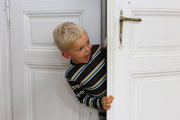 istock Little boy looking in through doors 187353879