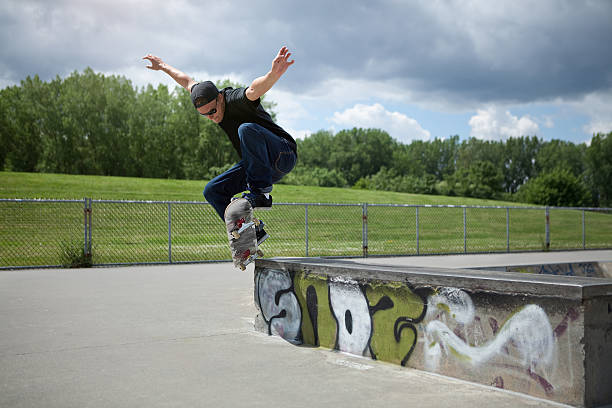 Skateboarder doing Wallie in a skatepark stock photo
