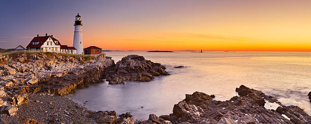 Portland Head Lighthouse, Maine, USA at sunrise The Portland Head Lighthouse in Maine, USA at sunrise. A seamlessly stitched panoramic image. lighthouse maine new england coastline stock pictures, royalty-free photos & images