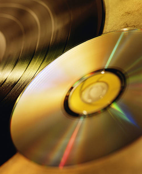Compact Disc and LP Record A compact disc and a LP record. vinal record stock pictures, royalty-free photos & images
