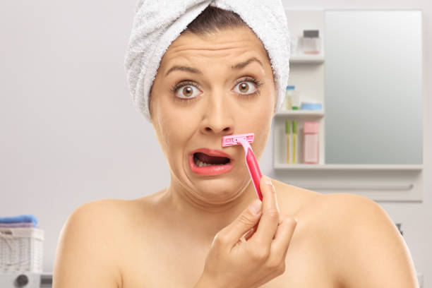 istock Shocked woman shaving her moustache 1873556761