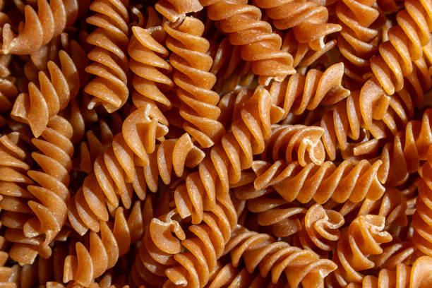 istock Uncooked Whole Grain Fusilli Pasta Background 1873561211