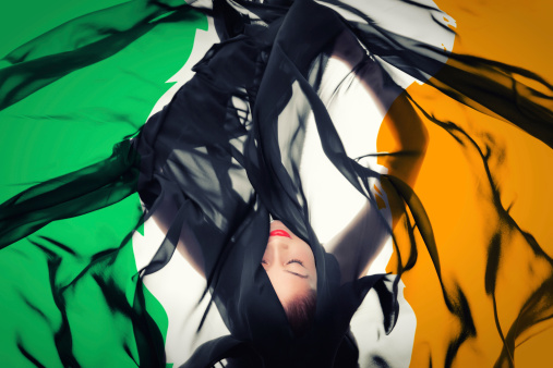 Beautiful woman laying in Irish Flag