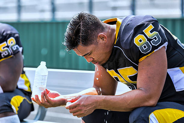 Football Player Sits on the Bench