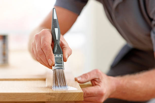 istock Applying varnish on wooden plank 187357035