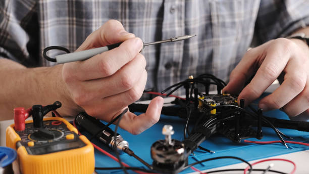 istock Repair Man Soldering Wires And Microchip Board On FPV Hobby Drone 1873574071