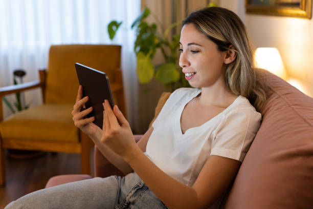istock Young woman looking at a modern digital tablet computer screen 1873574103