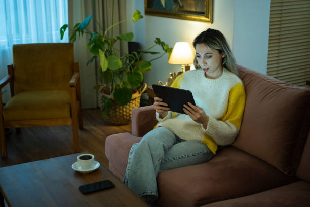 istock Young woman looking at a modern digital tablet computer screen 1873574108