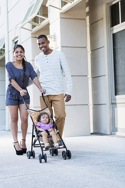 istock Young family with baby in stroller 187358603