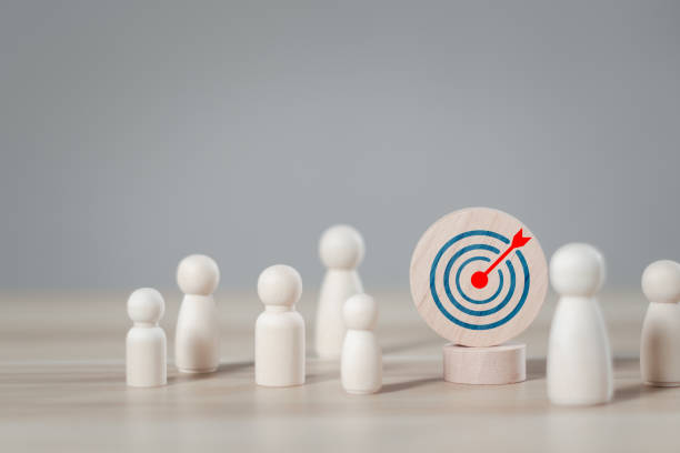 istock Customer relationship management concept. wooden block with target icon linked with human for customer focus group. Data exchanges development and customer service. 1873592034