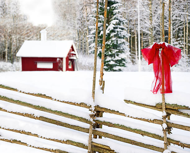 Christmas decoration on a rural fence.