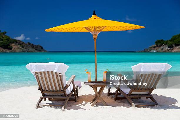 Steamers Under Umbrella At A Tropical Beach In The Caribbean Stock Photo - Download Image Now