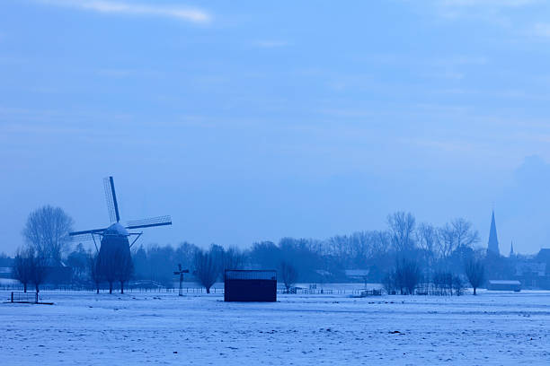 Dutch windmills in a winter landscape on a cold winter morning; Maasland, Netherlands